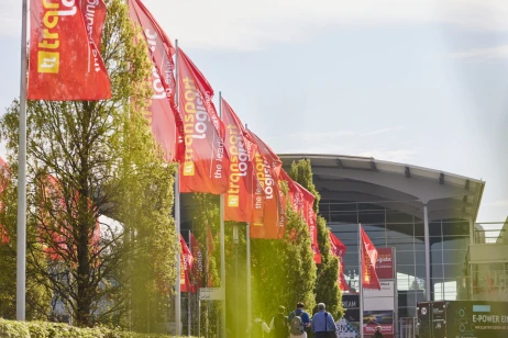 Red "transport logistic" flags waving in front of the West entrance of Messe München.