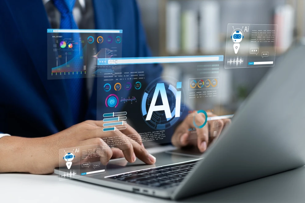 A business user works on a laptop with AI overlays showing dashboards, metrics, and chatbot interfaces. It’s suited for topics like enterprise AI, data analytics, AI-powered customer communication, and business process automation.