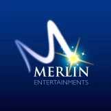 The Merlin Entertainments logo features a dynamic “M” with a star and glowing effects on a purple background, symbolizing theme parks, attractions, and global entertainment experiences. As a client of ISO-Gruppe, Merlin Entertainments relies on innovative IT and data solutions to efficiently manage visitor flows, ticketing, and digital services worldwide.