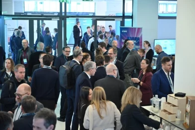 The image shows a busy conference networking scene and represents Digitaler Staat 2026 in Berlin on March 3–4. It highlights cross-sector exchange on public-sector digital transformation, including cloud, AI, and register modernization. ISO-Gruppe attends as a congress partner, presenting end-to-end IT services for e-government.