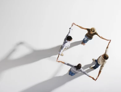 Several people are standing in a circular team formation seen from a top-down perspective on a bright background, holding hands. ISO Software Systems has been recognized in the Mittelstand 10,000 ranking by “Markt und Mittelstand,” in collaboration with Statista, as one of the Top 20 IT technology companies in Germany for 2025/2026. The ranking is considered a key reference for performance, stability, and future readiness in the midmarket.