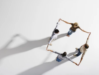 Several people are standing in a circular team formation seen from a top-down perspective on a bright background, holding hands. ISO Software Systems has been recognized in the Mittelstand 10,000 ranking by “Markt und Mittelstand,” in collaboration with Statista, as one of the Top 20 IT technology companies in Germany for 2025/2026. The ranking is considered a key reference for performance, stability, and future readiness in the midmarket.
